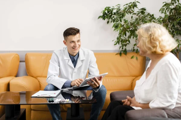 young-doctor-holding-tablet-looking-patient young-doctor-holding-tablet-looking-patient